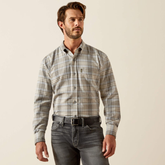 Man wearing a plaid shirt and jeans on a beige background